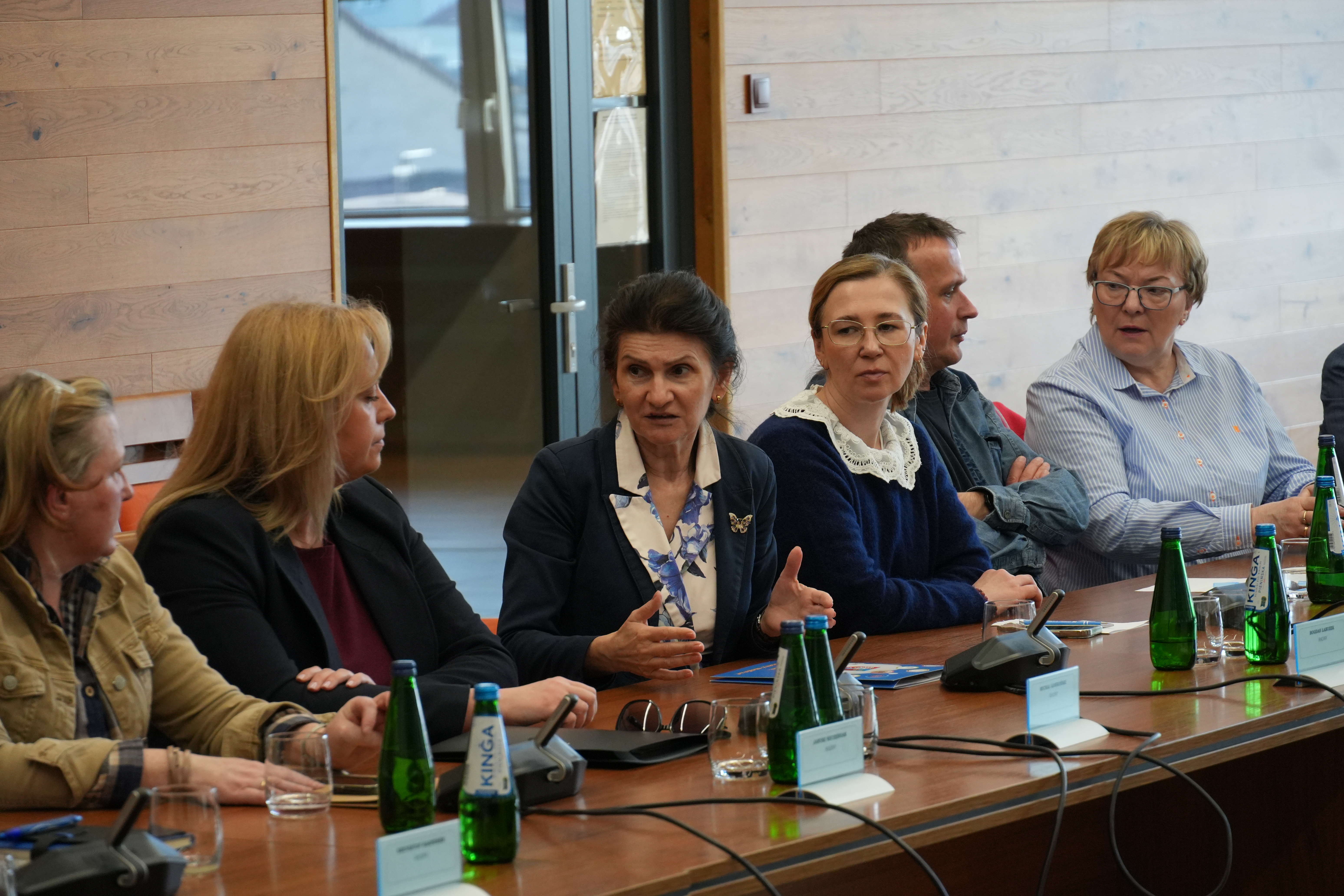 Zdjęcie kilkudziesięciu osób na sali narad siedzących przy stołach