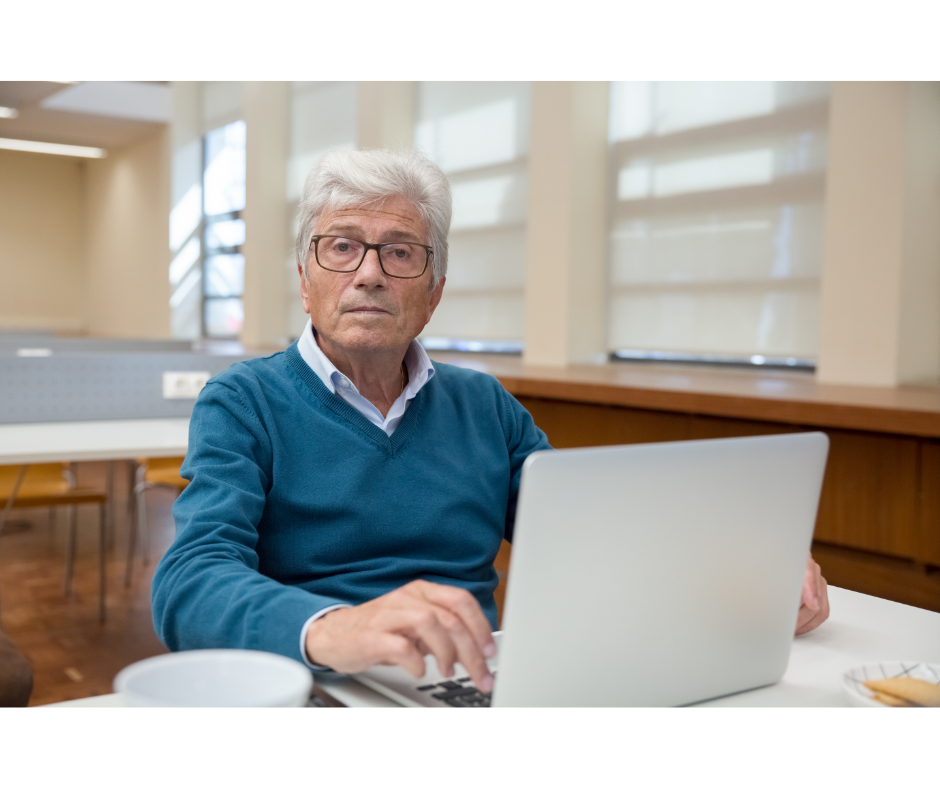 Starszy człowiek pracujący przed komputerem 