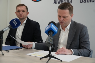 Dwóch mężczyzn, przed nimi mikrofony 