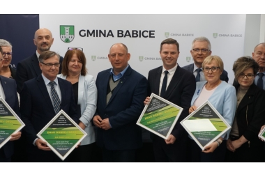 Wspólna fotografia jedynastu osób. Niektóre z osób trzymają tabliczki w ramkach.