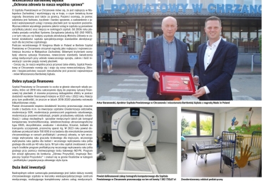 Makieta gazety ze zdjęciem dwóch mężczyzn trzymających pamiąkową paterę 