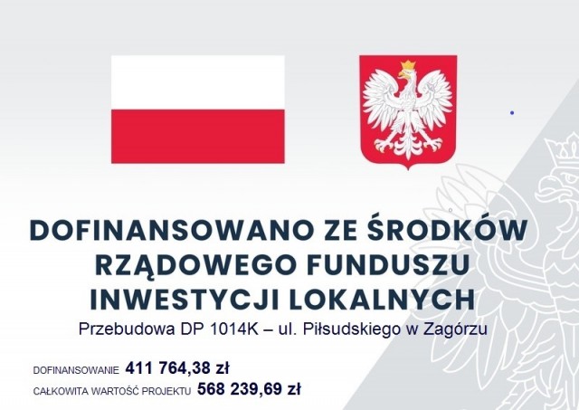 tavlica z flagą i godłem RP napis dofinanoswano ze srodkó rządowego funduszu inwestycji lokalnych Przebudowa DP 1014K - ul. Piłsudskiego w Zagórzu , dofinansowanie 411 764,38 zł, wartosć proj: 568 239